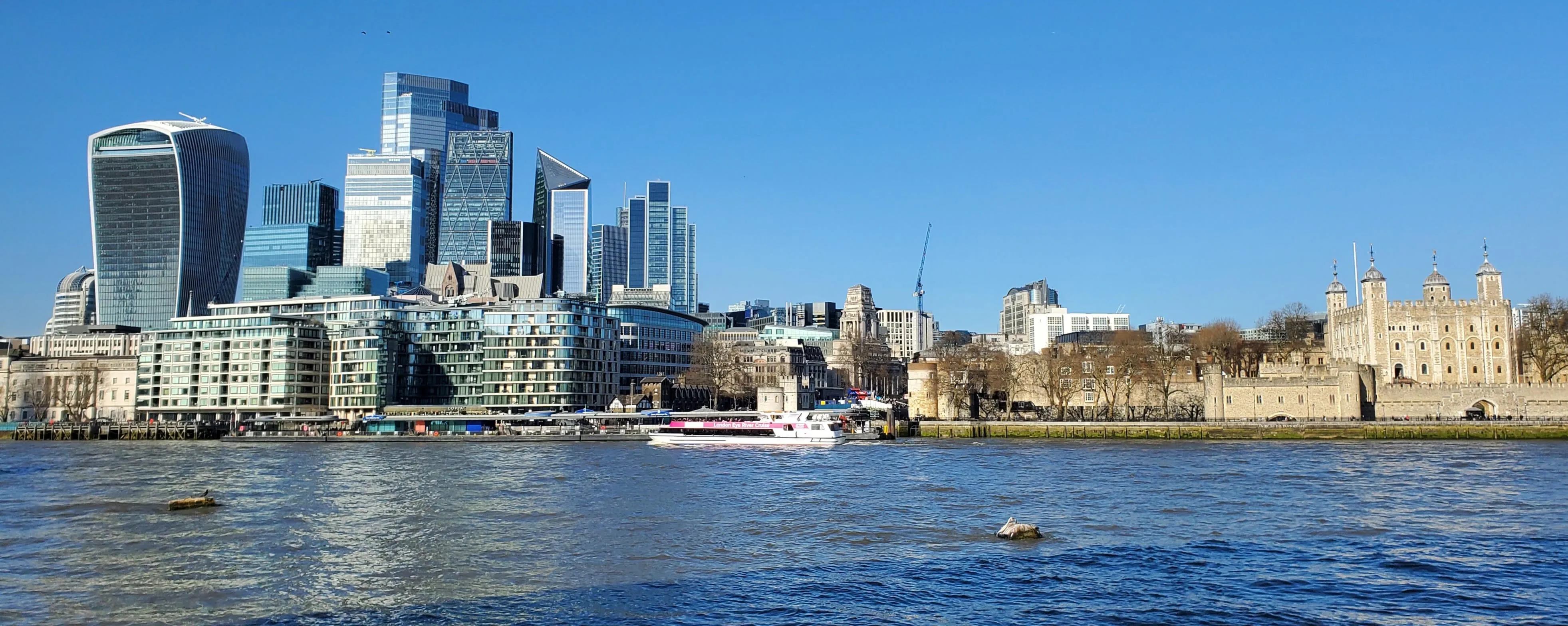 The City of London skyline seen across the River Thames, with the Tower of London to the right
